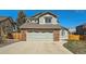 Charming home featuring a two-car garage with a brick facade and neutral trim at 10707 W Cooper Dr, Littleton, CO 80127