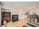 Open-concept living area featuring a fireplace and seamless access to the kitchen at 10707 W Cooper Dr, Littleton, CO 80127