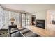 Cozy living room with a fireplace, hardwood floors, and sliding glass doors at 10707 W Cooper Dr, Littleton, CO 80127