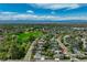 Aerial view showing neighborhood with mature trees, large yards, and proximity to a green park space at 4790 E Dartmouth Ave, Denver, CO 80222