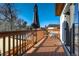 Expansive wooden back deck with umbrella and railing offers a private outdoor living space at 4790 E Dartmouth Ave, Denver, CO 80222