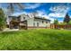 Spacious backyard featuring lush green grass, a charming pergola, and a playhouse at 4790 E Dartmouth Ave, Denver, CO 80222
