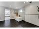 Modern bathroom featuring a soaking tub, glass-enclosed shower with stylish black and white tiling at 4790 E Dartmouth Ave, Denver, CO 80222