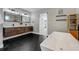 Bathroom features double vanity with modern fixtures and black hexagon tile floor at 4790 E Dartmouth Ave, Denver, CO 80222