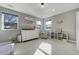 Bright bedroom with white furniture and three windows at 4790 E Dartmouth Ave, Denver, CO 80222