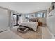 Main bedroom with private deck access and neutral decor at 4790 E Dartmouth Ave, Denver, CO 80222