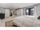 Bright bedroom with a cozy atmosphere, featuring a large bed and access to a private balcony at 4790 E Dartmouth Ave, Denver, CO 80222
