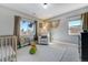 Cozy Bedroom with a crib, rocking chair, and plenty of natural light at 4790 E Dartmouth Ave, Denver, CO 80222