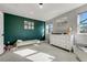Bright bedroom with green accent wall and white furniture at 4790 E Dartmouth Ave, Denver, CO 80222