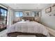 Bright bedroom with king bed, two windows, and French door to balcony at 4790 E Dartmouth Ave, Denver, CO 80222