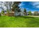Beautiful home with lush green lawn and a charming fence creating a private outdoor space at 4790 E Dartmouth Ave, Denver, CO 80222