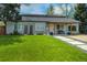 Charming home featuring a well-manicured lawn and inviting entrance with modern walkway and covered porch at 4790 E Dartmouth Ave, Denver, CO 80222