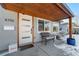 Charming front porch with a modern door, bench seating, and attractive address numbers at 4790 E Dartmouth Ave, Denver, CO 80222