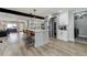 Modern kitchen with white cabinets, a large island, and stainless steel appliances at 4790 E Dartmouth Ave, Denver, CO 80222