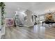 Open-concept living room boasts hardwood floors, stairs, modern lighting, and dining area at 4790 E Dartmouth Ave, Denver, CO 80222