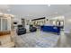 Spacious living room showcasing modern furniture, a patterned rug, and access to the kitchen and dining area at 4790 E Dartmouth Ave, Denver, CO 80222