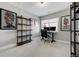 Home office with built-in shelving and window views at 4790 E Dartmouth Ave, Denver, CO 80222