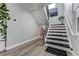 Modern staircase with metal railing and geometric runner at 4790 E Dartmouth Ave, Denver, CO 80222