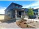 Charming two-story home with a welcoming front porch, a two-car garage, and xeriscaped front yard at 10976 Snowdon St, Parker, CO 80134