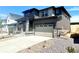 Stylish two-story home with a two-car garage and stone accents, complemented by low-maintenance landscaping at 10976 Snowdon St, Parker, CO 80134