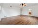 Bedroom with ceiling fan, wood-look floors, and ensuite bath access at 12702 E 105Th Ave, Commerce City, CO 80022