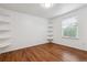 Cozy room features hardwood floors, white walls, and wall shelves, creating a clean and organized space at 12702 E 105Th Ave, Commerce City, CO 80022