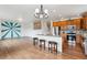 Bright kitchen with island seating opens to a living space featuring a statement wall at 12702 E 105Th Ave, Commerce City, CO 80022