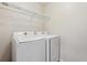 Laundry room with white washer and dryer and convenient wire shelving for storage at 12702 E 105Th Ave, Commerce City, CO 80022