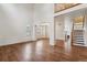Open living room with high ceilings, wood floors, and an abundance of natural light at 12702 E 105Th Ave, Commerce City, CO 80022