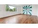 Bright living room with large window offering natural light and featuring stylish wall art at 12702 E 105Th Ave, Commerce City, CO 80022