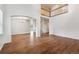 Bright living room with a soaring ceiling, open landing, and wood laminate flooring at 12702 E 105Th Ave, Commerce City, CO 80022
