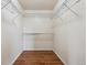 Bright walk-in closet features wood floor and white walls with wire shelving ready for organization at 12702 E 105Th Ave, Commerce City, CO 80022