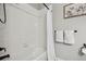 Well-lit tub and shower combo with white tiled walls and dark hardware at 2328 Saddle Back Ct, Fort Lupton, CO 80621