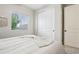 Bedroom features large window, neutral color palette, and closet with sliding doors at 2328 Saddle Back Ct, Fort Lupton, CO 80621