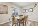 Bright dining area with a wooden table, seating for six, and a sliding glass door to the backyard at 2328 Saddle Back Ct, Fort Lupton, CO 80621