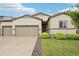 Charming home with a two-car garage, well-maintained lawn, and lovely landscaping at 2328 Saddle Back Ct, Fort Lupton, CO 80621