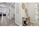 Bright hallway with a charming console table, leading to the living area and bedrooms at 2328 Saddle Back Ct, Fort Lupton, CO 80621