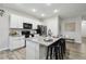 Kitchen featuring an island with granite countertops, bar stools, and ample storage space at 2328 Saddle Back Ct, Fort Lupton, CO 80621
