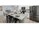 Modern kitchen with stainless steel appliances, a granite countertop island, and bar stool seating at 2328 Saddle Back Ct, Fort Lupton, CO 80621