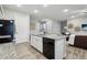 Stylish kitchen featuring a functional island, stainless steel dishwasher, and open-concept design at 2328 Saddle Back Ct, Fort Lupton, CO 80621