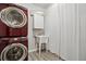 Well-equipped laundry room with red front load washer and dryer, utility sink, and storage cabinet at 2328 Saddle Back Ct, Fort Lupton, CO 80621