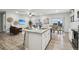 Open floor plan showcases a spacious living room, modern kitchen with granite countertops, and dining area at 2328 Saddle Back Ct, Fort Lupton, CO 80621
