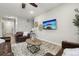 Comfortable living room featuring modern decor, leather seating, and a flatscreen TV at 2328 Saddle Back Ct, Fort Lupton, CO 80621