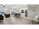 Spacious open-concept living area connecting the living room, dining area, and kitchen with an island at 2328 Saddle Back Ct, Fort Lupton, CO 80621