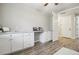 Bright home office featuring built-in desk, laminate flooring, and a ceiling fan at 2328 Saddle Back Ct, Fort Lupton, CO 80621
