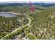 An aerial view of a town in a forest by a river and mountains at 28127 Knowles Rd # Ab&C, Evergreen, CO 80439