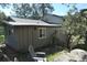 Wood paneled exterior view featuring gray chairs, rock landscaping, and a partial view of roof at 28127 Knowles Rd # Ab&C, Evergreen, CO 80439