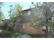 An exterior view of the side and back of a house with brick and siding and trees at 28127 Knowles Rd # Ab&C, Evergreen, CO 80439