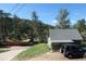 A charming house with a gray roof, a car parked out front, and surrounded by trees at 28127 Knowles Rd # Ab&C, Evergreen, CO 80439
