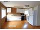 A functional kitchen featuring white cabinets, laminate countertops, and a washer and dryer at 28127 Knowles Rd # Ab&C, Evergreen, CO 80439